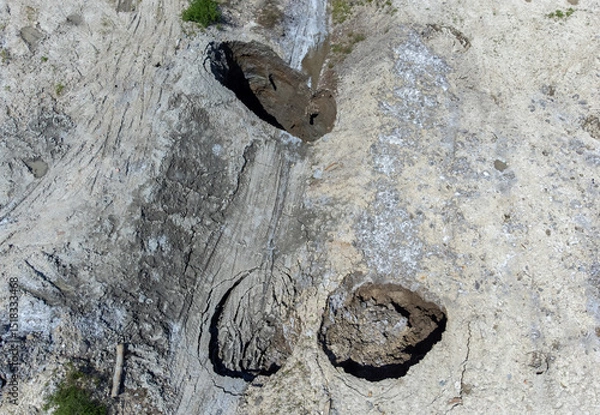 Obraz Aerial view of the place where the ground collapsed, forming holes due to the erosion of the ceiling of the salt mine in Praid - Romania