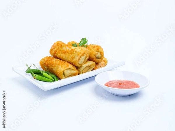 Fototapeta Indonesian crispy rissoles , served on a white plate with spicy red chili sauce and green chili on a white background. Perfect photo of a traditional snack.