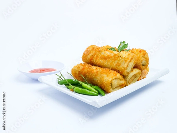 Fototapeta Indonesian crispy rissoles , served on a white plate with spicy red chili sauce and green chili on a white background. Perfect photo of a traditional snack.