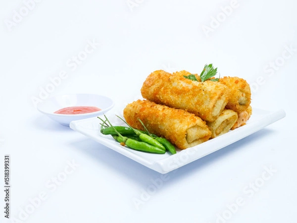 Fototapeta Indonesian crispy rissoles , served on a white plate with spicy red chili sauce and green chili on a white background. Perfect photo of a traditional snack.