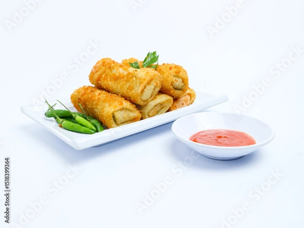 Fototapeta Indonesian crispy rissoles , served on a white plate with spicy red chili sauce and green chili on a white background. Perfect photo of a traditional snack.