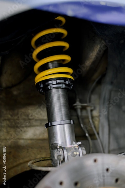 Fototapeta Yellow springs for cars.Upgrade your car's springs to be more efficient.Install new springs and shocks into the vehicle.Install springs and shocks on the front of the vehicle.