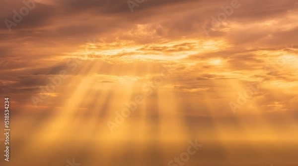 Fototapeta Golden celestial rays pierce through the clouds