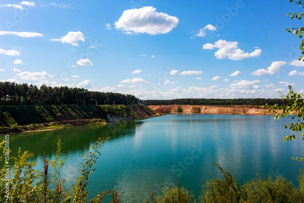 Fototapeta Large sand quarry artificially converted into a lake, panoramic view of the reservoir