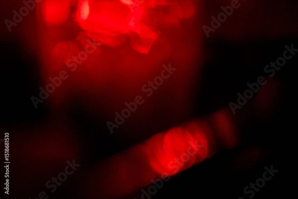 Obraz Abstract red lens flare effect on black background for design. Random color and light shapes.