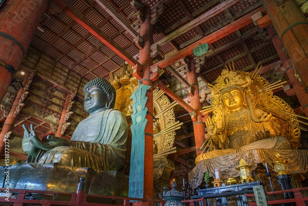 Fototapeta Nara, Japan - Sep 26 2024, Panoramic view of the Sitting Buddha Vairochana, a fifteen-meter bronze statue of Buddha, and a side-standing gilded statue of Buddha, at Todaiji Temple, Nara, Japan