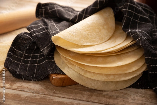Fototapeta Tortillas de Harina, also called wheat tortilla, is a flat bread made with wheat flour and lard or butter, without yeast, and widely consumed daily in Mexico, especially in the north of the country.