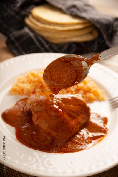 Fototapeta Pipian with Chicken, food from Mexico and other Latin American countries, chicken meat bathed in mole sauce made with pumpkin seeds, dried chili peppers and several other ingredients.