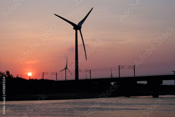Obraz Silhouette of wind turbines and a bridge over water at sunset, captured on October 7, 2012, in Miaoli County, Taiwan.