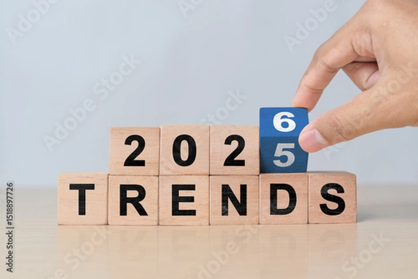 Obraz Hand flipping wooden cube from 2025 to 2026. New year concept for business, fashion, and technology trend changes and future planning