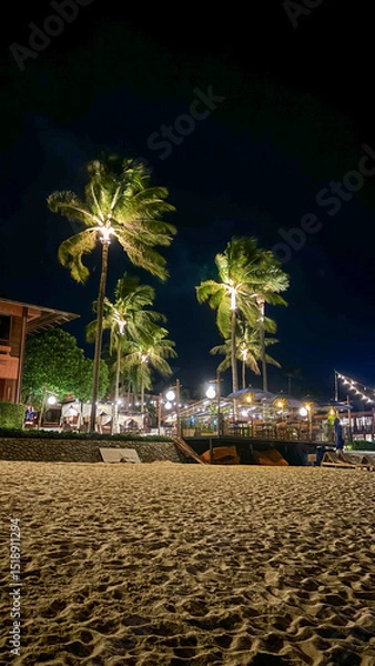 Fototapeta Beautiful Nighttime View of the Beach with Palm Trees in the Foreground, Fisherman's Village, Koh Samui, Thailand