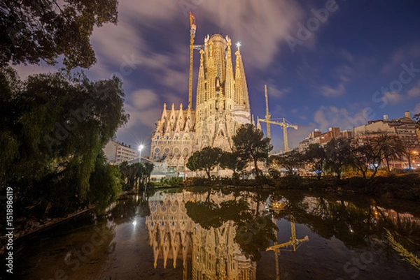 Fototapeta The illuminated Nativity Facade of the famous Sagrada Familia in Barcelona at blue hour
