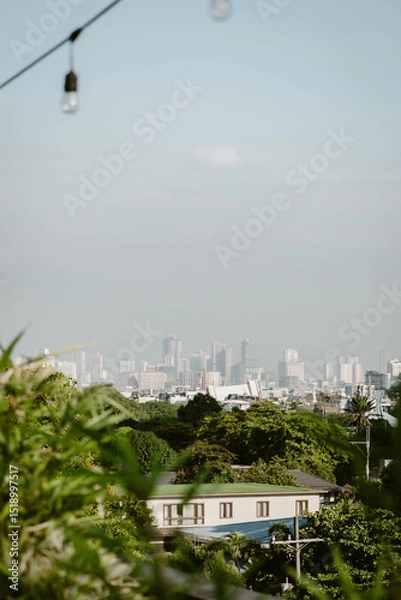 Fototapeta Stunning cityscape of the skyline of Manila outdoor at daytime on a hazy morning on the roof of a hotel during a holiday in the Philippines in South East Asia with space for text.