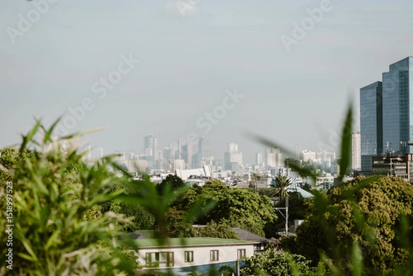 Fototapeta Stunning cityscape of the skyline of Manila outdoor at daytime on a hazy morning on the roof of a hotel during a holiday in the Philippines in South East Asia with space for text.