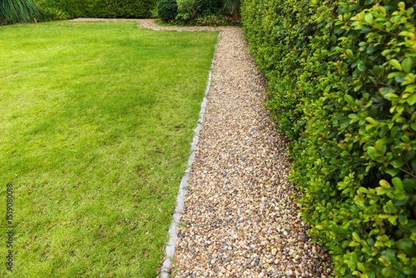 Fototapeta Splash Strips are the narrow band of gravel installed in between lawn and wall of house.