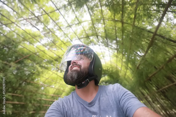 Fototapeta Bearded hipster guy in motorcycle helmet, happy portrait