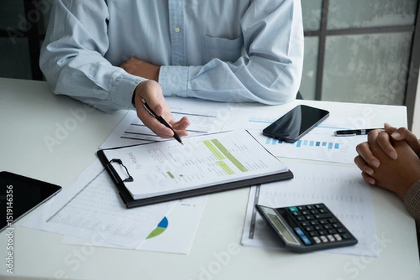 Fototapeta Businessman and businesswoman working together in an office
