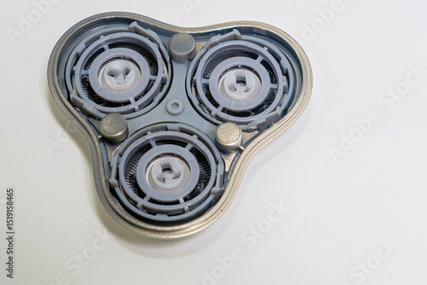 Fototapeta Inner mechanism of a shaver head showing intricate components with a silver outline