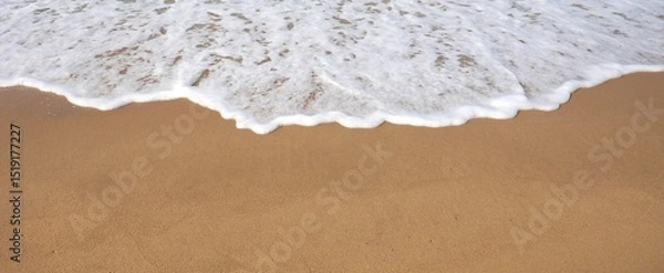 Fototapeta Waves crashing onto shore and sandy beaches in summer