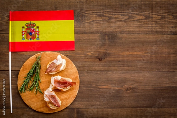 Obraz Welcome to Spain. Parma ham and Spanish flag, top view
