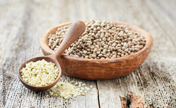 Fototapeta Hemp seeds in closeup on wooden board