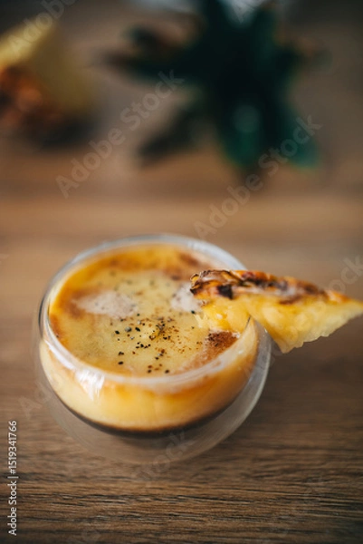Fototapeta Exotic fresh pineapple puree with espresso coffee drink in double-bottom transparent glass