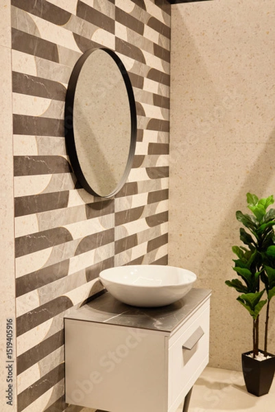 Fototapeta Sleek basin rests atop a modern cabinet, complemented by an elegant round mirror and minimalist wall design in a tranquil bathroom layout