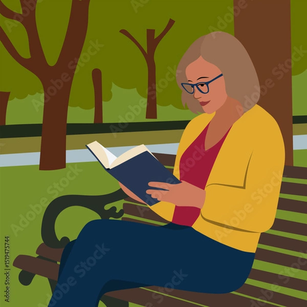 Fototapeta A woman with glasses sits on a bench in a park and reads a book against the background of trees