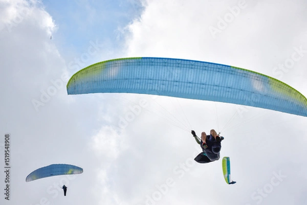 Obraz Paragliding pilot taking off in a competition