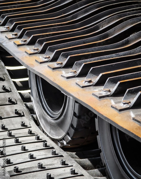 Obraz Heavy machinery tracks and wheels in motion during construction work at a building site