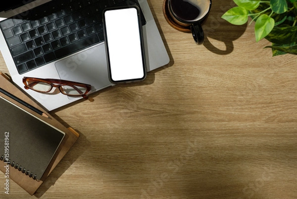 Obraz Creative desk including laptop, mobile phone with blank screen, and planner in natural lighting.
