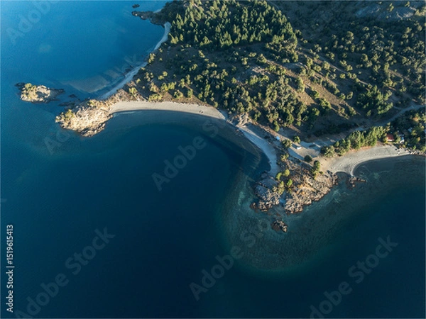 Fototapeta Aerial top view shows the shoreline of a deep blue lake meeting sandy beaches
