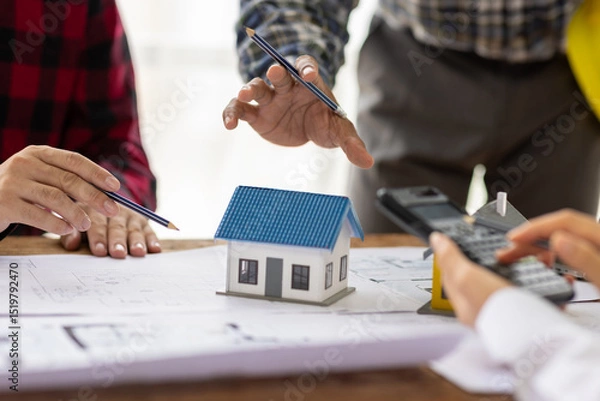 Obraz Architects and engineers are having a meeting in their office. They are working on a construction project and using a calculator to calculations. Building construction design and plan project budget.