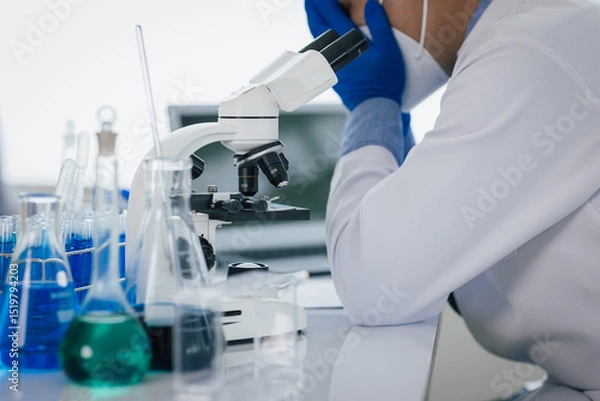 Obraz Medical scientist feeling stressed while working using microscope in laboratory, feeling stressed while doing some research, failed experiment.