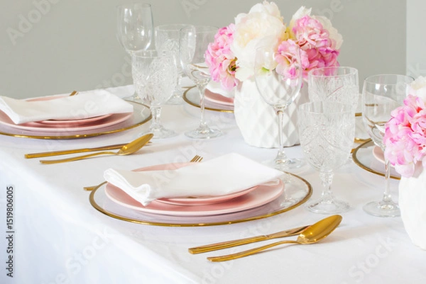 Fototapeta Elegant wedding table setting with pink peonies, gold cutlery, and crystal glassware, creating a romantic and sophisticated atmosphere.