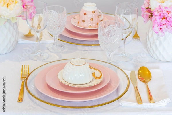Fototapeta Elegant wedding table setting with pink peonies, gold cutlery, and crystal glassware, creating a romantic and sophisticated atmosphere.