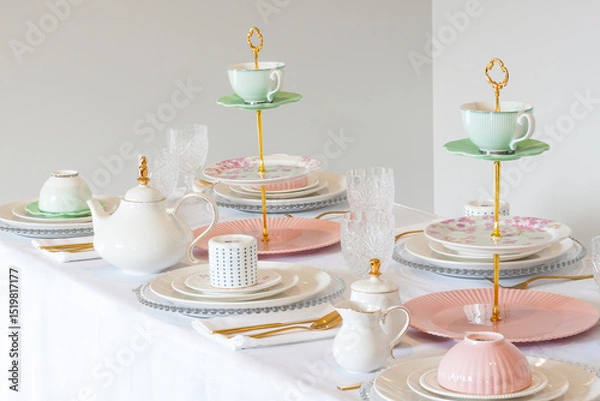 Fototapeta Elegant wedding table setting with pink peonies, gold cutlery, and crystal glassware, creating a romantic and sophisticated atmosphere.