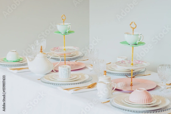 Fototapeta Elegant wedding table setting with pink peonies, gold cutlery, and crystal glassware, creating a romantic and sophisticated atmosphere.