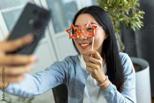 Fototapeta Young Thai Woman Taking a Selfie with Star-Shaped Glasses