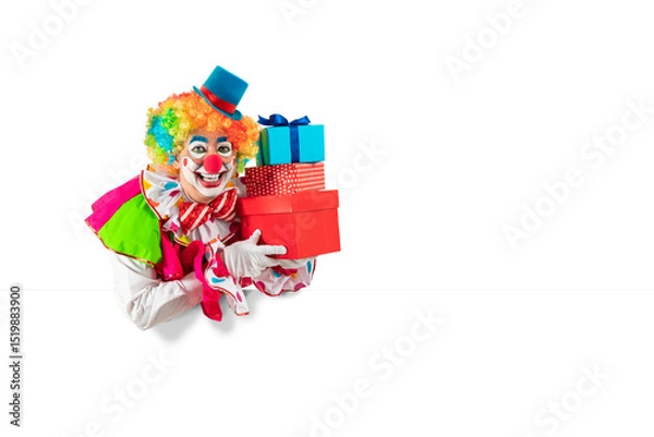 Fototapeta Funny clown with gifts, man entertainer as Joker in a suit and wig, with clown whiteface makeup. Trickster, jester, pantomime, mime, and a professional actor at events, birthday party
