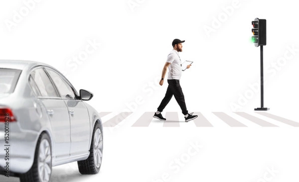 Fototapeta Full length profile shot of a sports coach walking on street at zebra crossing