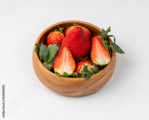 Fototapeta Group of strawberries in a wooden bowl on a white background
