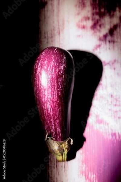Obraz An eye-catching eggplant painted on a wall catches the eye, blending colors and textures in a narrow alley during twilight. This artwork transforms the ordinary into extraordinary