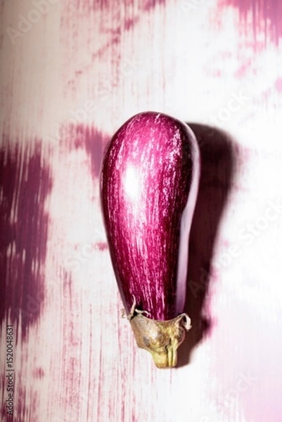 Obraz Bright graffiti artwork portrays a striking eggplant against a textured, colorful wall. This creative expression captures the intersection of art and urban life in a lively city
