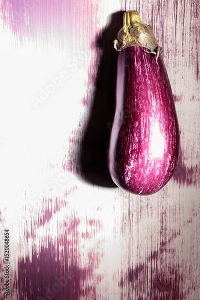 Obraz A striking eggplant is painted on a textured urban wall, surrounded by an array of vibrant colors. This unique graffiti piece transforms the ordinary into extraordinary, igniting artistic imagination