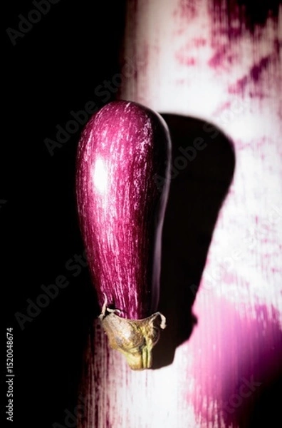 Obraz Colorful graffiti artwork vividly depicts an eggplant on a city wall at dusk, enhancing the urban landscape with its quirky charm and creativity. The piece draws in passersby with its charm