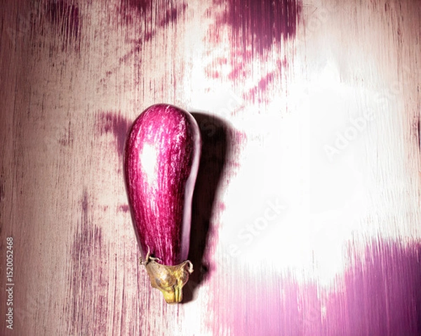 Obraz A colorful eggplant design stands out against a textured wall, reflecting the artist's unique style. This artwork brightens up an urban setting with its vibrant hues and creativity