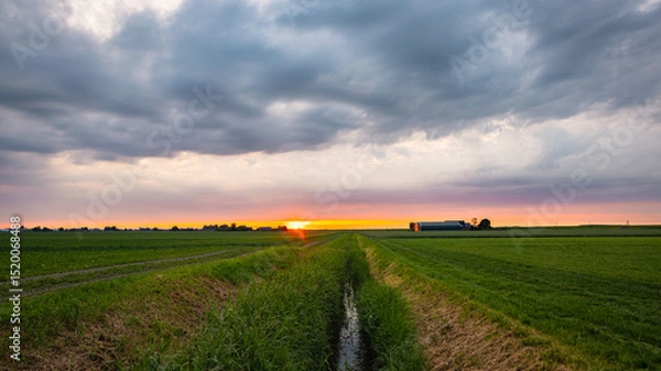 Obraz Sunset sky over a small long ditch in the Dutch countryside