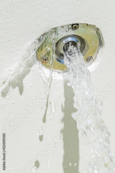 Fototapeta The water inlet of a reinforced concrete pool is defective and the water also comes out laterally