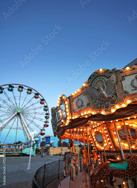 Obraz The carousel and ferris wheel at the boardwalk in Carolina Beach, North Carolina